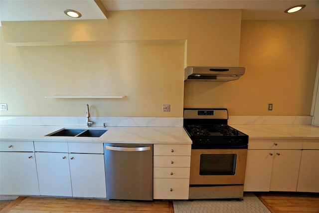 kitchen with sink, white cabinets, and stainless steel appliances