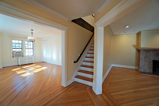 staircase featuring radiator heating unit, cooling unit, a notable chandelier, hardwood / wood-style flooring, and crown molding