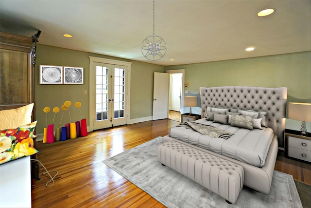 bedroom with wood-type flooring, access to exterior, and french doors