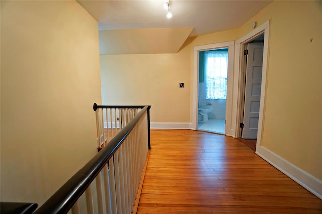 corridor with light hardwood / wood-style flooring