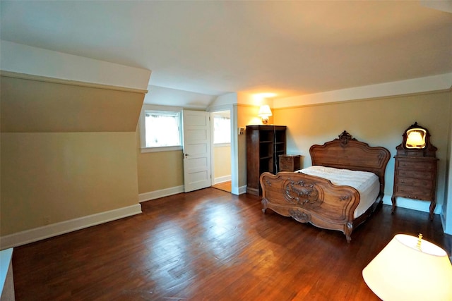 bedroom featuring dark wood-type flooring and lofted ceiling