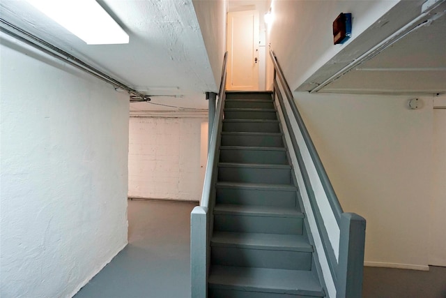 stairs featuring concrete floors