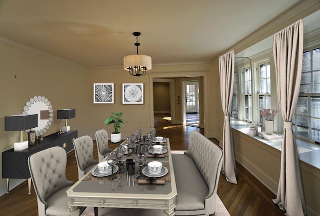 dining area with dark hardwood / wood-style floors, crown molding, and an inviting chandelier