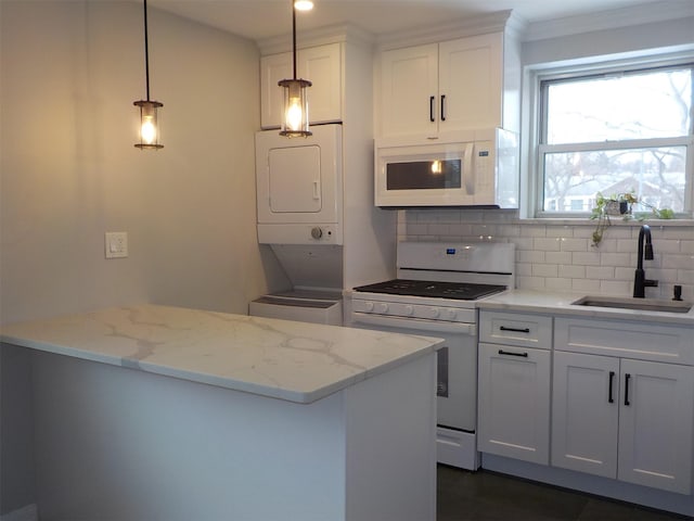 kitchen featuring decorative light fixtures, sink, white cabinets, and white appliances