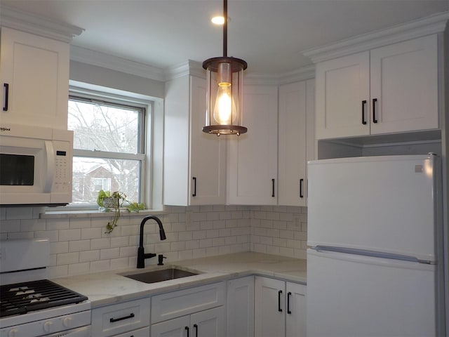 kitchen featuring white cabinetry, sink, backsplash, and white appliances