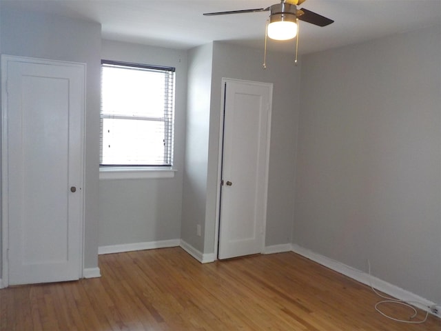 spare room featuring ceiling fan and light wood-type flooring