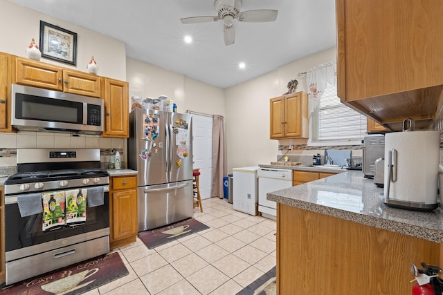 kitchen with appliances with stainless steel finishes, decorative backsplash, light tile patterned floors, ceiling fan, and light stone counters