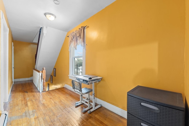 interior space featuring wood-type flooring and a baseboard radiator