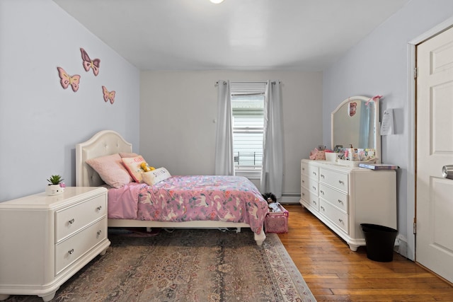 bedroom featuring dark wood-type flooring and baseboard heating