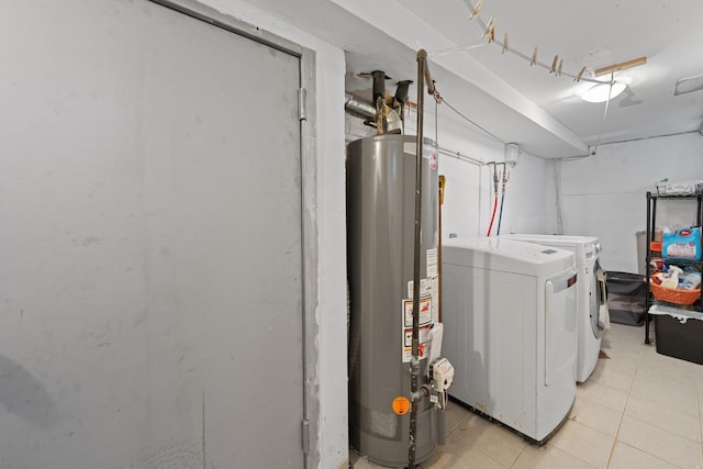 laundry room with light tile patterned floors, gas water heater, and independent washer and dryer