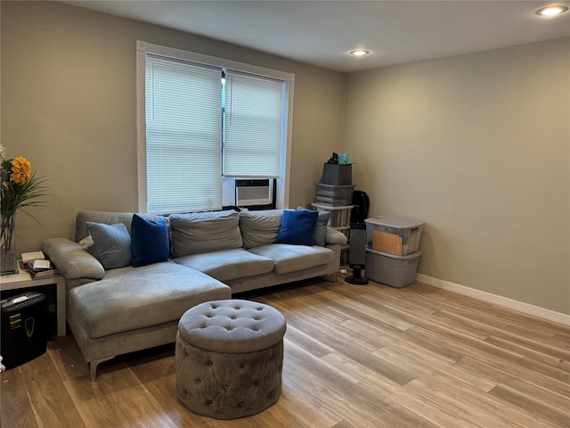 living room with cooling unit and light wood-type flooring