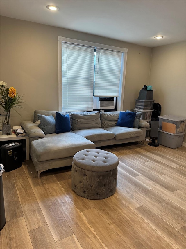 living room featuring cooling unit and light hardwood / wood-style floors