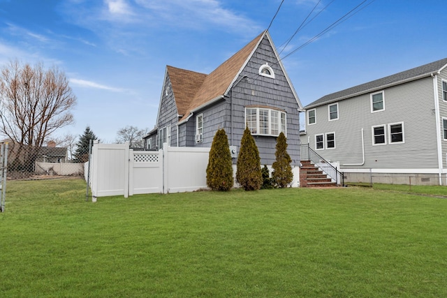 rear view of house with a yard