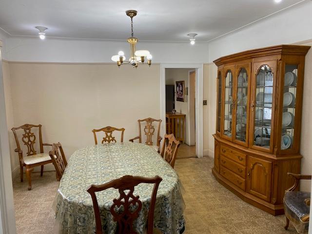 dining area with an inviting chandelier