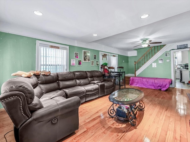 living room featuring ceiling fan and hardwood / wood-style floors