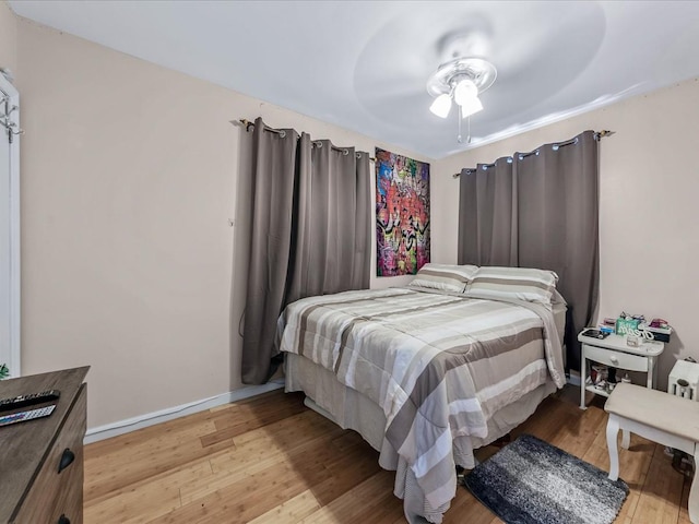 bedroom with ceiling fan and light hardwood / wood-style flooring