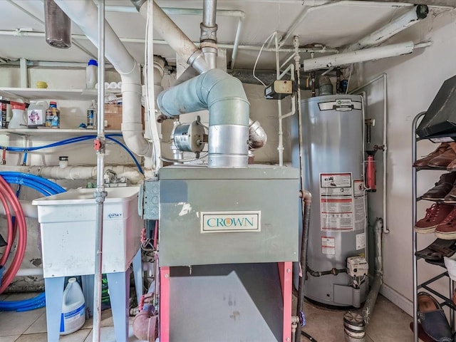 utility room with sink and gas water heater