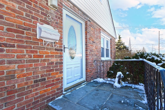 view of snow covered property entrance