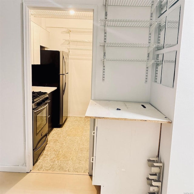 kitchen featuring range with gas cooktop and light tile patterned flooring