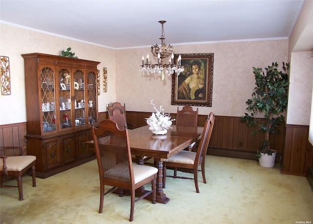 carpeted dining room featuring a baseboard radiator, crown molding, and a chandelier