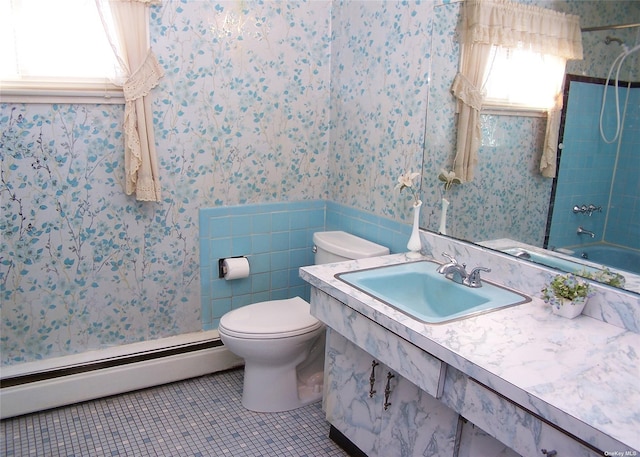 full bathroom featuring toilet, tile patterned floors, sink, bathtub / shower combination, and baseboard heating