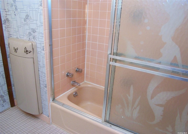 bathroom with shower / bath combination with glass door and tile patterned flooring