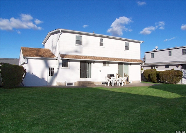 rear view of house featuring a patio area and a yard