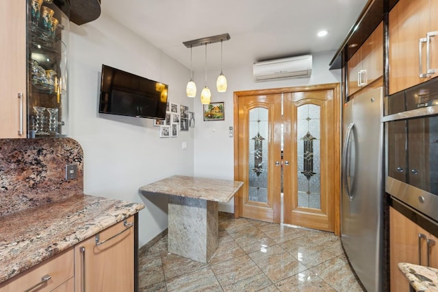 kitchen with pendant lighting, light stone counters, kitchen peninsula, stainless steel appliances, and a wall unit AC