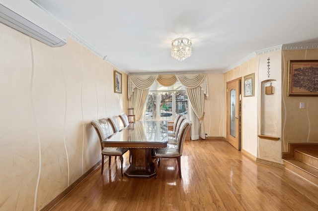 dining area with a wall mounted air conditioner, hardwood / wood-style flooring, and ornamental molding