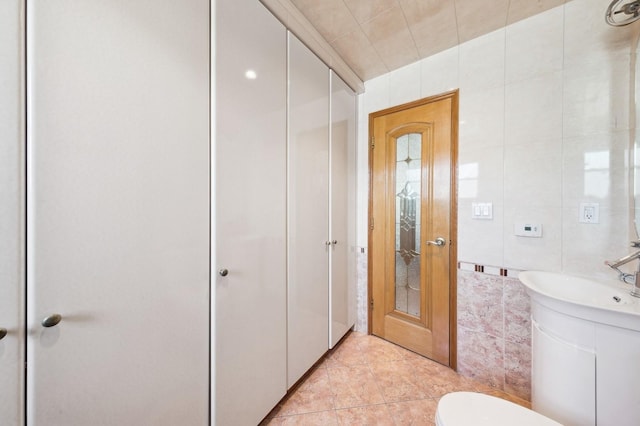 bathroom featuring vanity, tile walls, tile patterned floors, and toilet