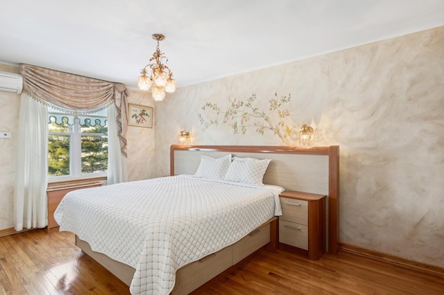 bedroom featuring hardwood / wood-style floors and a chandelier