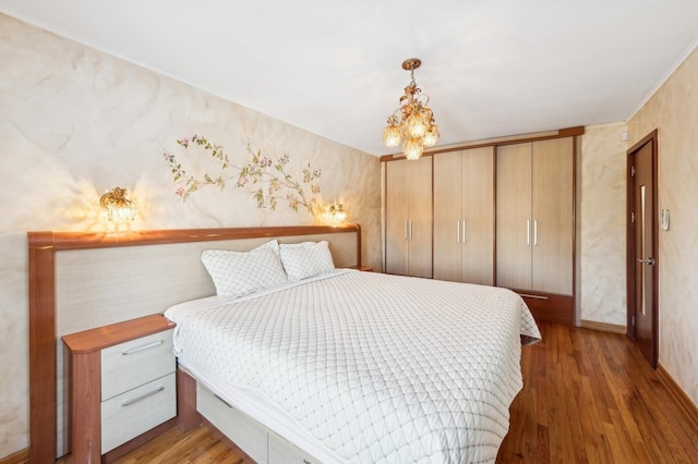 bedroom featuring dark hardwood / wood-style floors and a notable chandelier