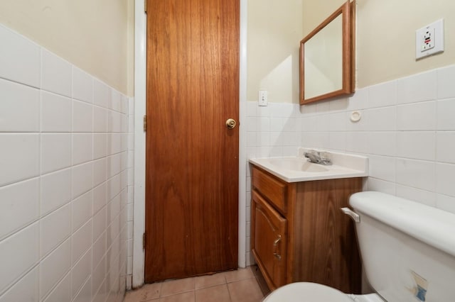 bathroom featuring vanity, tile walls, tile patterned floors, and toilet