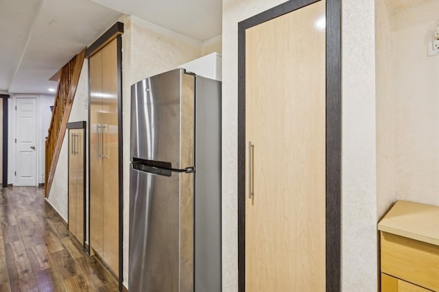 kitchen with dark hardwood / wood-style floors and stainless steel refrigerator