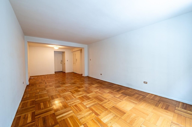 unfurnished room featuring light parquet flooring