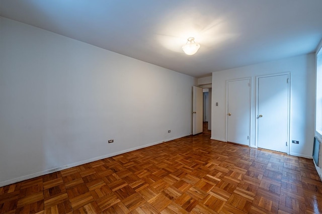 unfurnished bedroom with parquet flooring