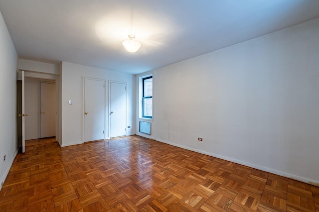 unfurnished bedroom featuring parquet floors