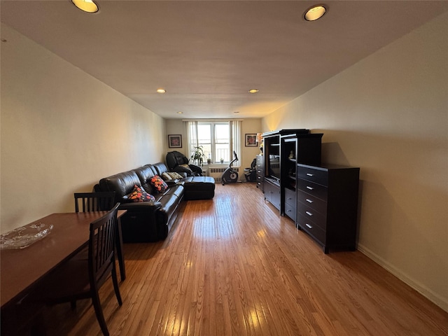 living room with radiator heating unit and hardwood / wood-style floors