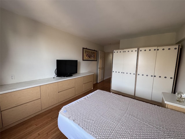 unfurnished bedroom with dark hardwood / wood-style floors