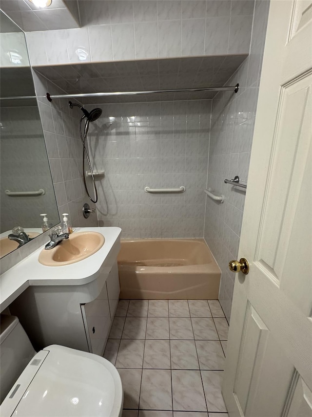 full bathroom featuring toilet, vanity, tiled shower / bath, and tile patterned flooring