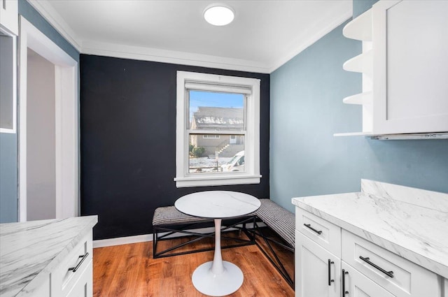 interior space featuring crown molding and wood-type flooring