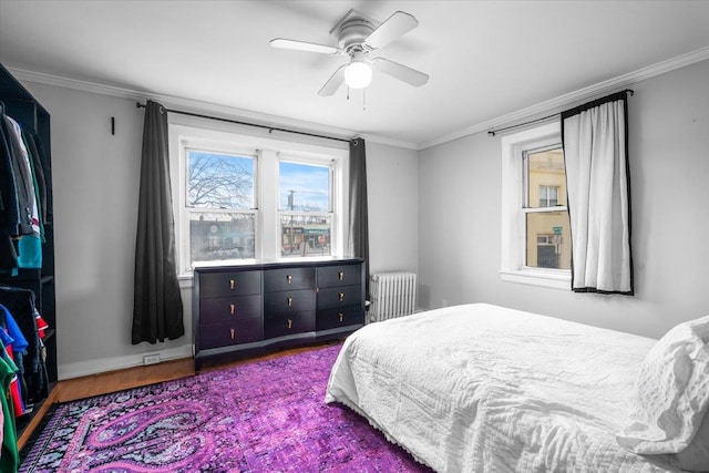 bedroom featuring ornamental molding, radiator, and ceiling fan