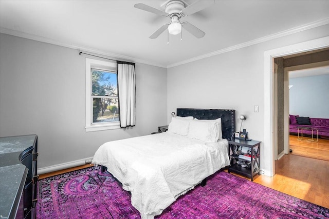 bedroom with crown molding, hardwood / wood-style floors, and ceiling fan