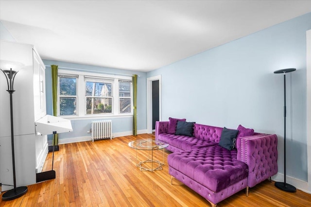 living room featuring radiator and light wood-type flooring