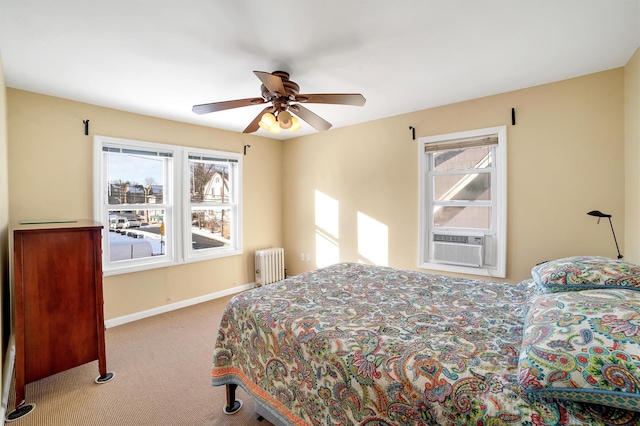 bedroom featuring ceiling fan, light colored carpet, cooling unit, and radiator heating unit