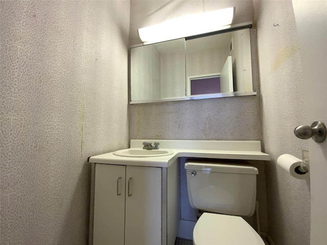 bathroom featuring vanity and toilet