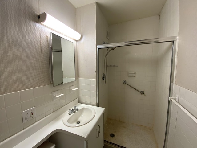 bathroom featuring decorative backsplash, tile walls, an enclosed shower, and vanity