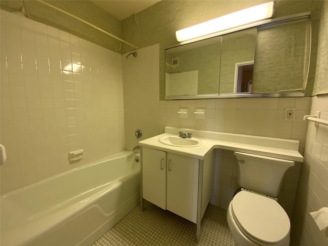 full bathroom with toilet, tile walls, decorative backsplash, vanity, and  shower combination