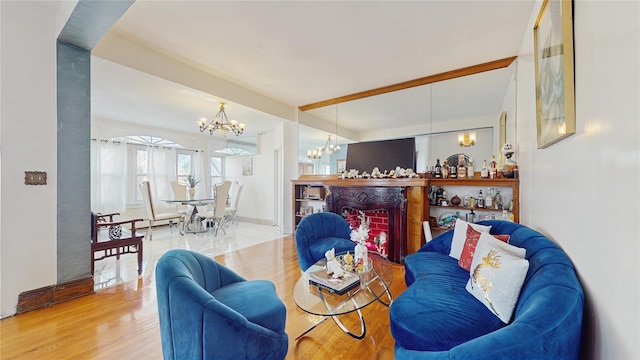 living room featuring beam ceiling, hardwood / wood-style floors, and a notable chandelier