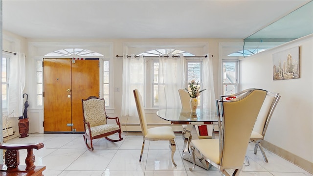 dining area featuring a baseboard heating unit